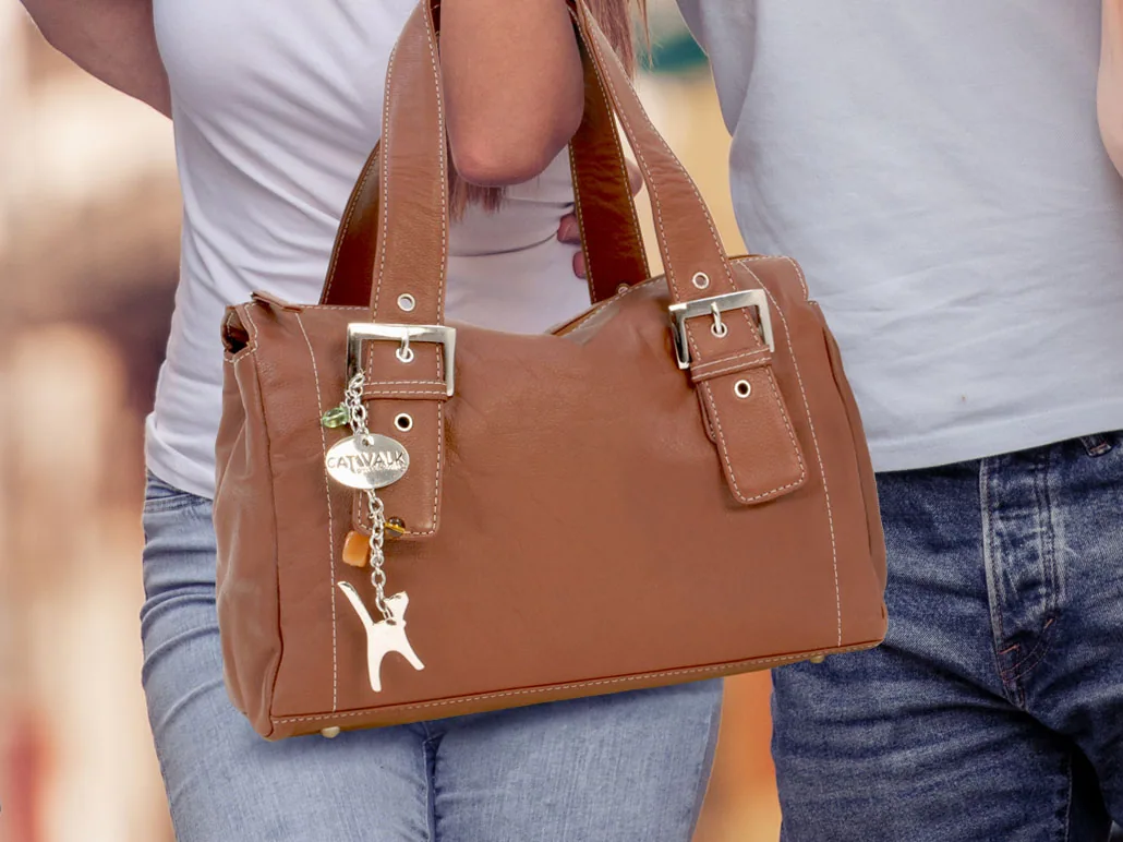Catwalk handbag reference photography — worn in real-world context